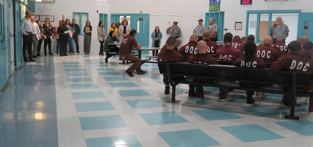 SCI Greene inmates and staff in a room with a group of corrections professionals from across the country