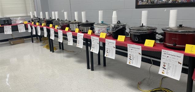 A row of crockpots cooking chili