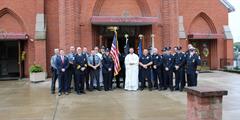 SCI Houtzdale's Honor Guard stands with priests outside a cathedral