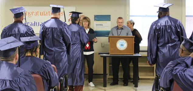 SCI Laurel Highlands inmate graduates receive their diplomas at their graduation ceremony
