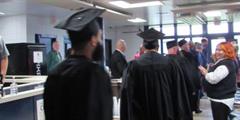 Incarcerated students at SCI Rockview walk in a processional at their academic graduation ceremony.