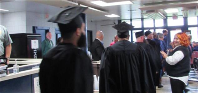 Incarcerated students at SCI Rockview walk in a processional at their academic graduation ceremony.