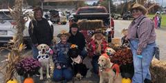 K9 Connection volunteers and SCI Somerset Prison Pups sit for a photo at their Trunk-or-Treat area.