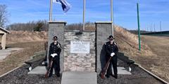 The SCI Somerset Honor Guard stand by a memorial at the range in honor of Sgt. Mark Baserman.