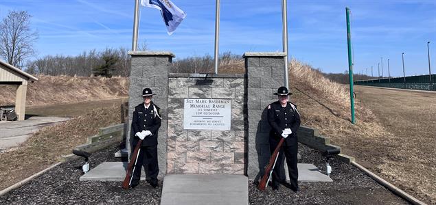 The SCI Somerset Honor Guard stand by a memorial at the range in honor of Sgt. Mark Baserman.