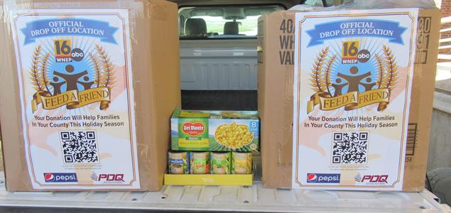Two boxes and donated food in the back of a truck