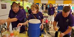 Three employees from SCI Waymart make fresh lemonade while serving in a 12 Months of Kindness service project.