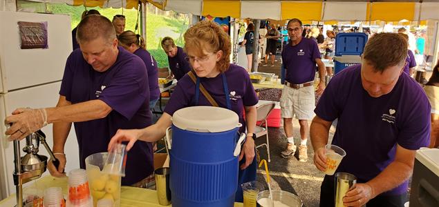 Three employees from SCI Waymart make fresh lemonade while serving in a 12 Months of Kindness service project.
