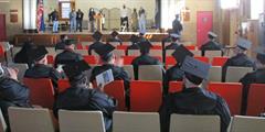 Inmate graduates sit during a ceremony