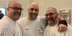 Three men stand after getting buzzcuts