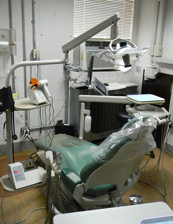 A dental chair with dental instruments around it