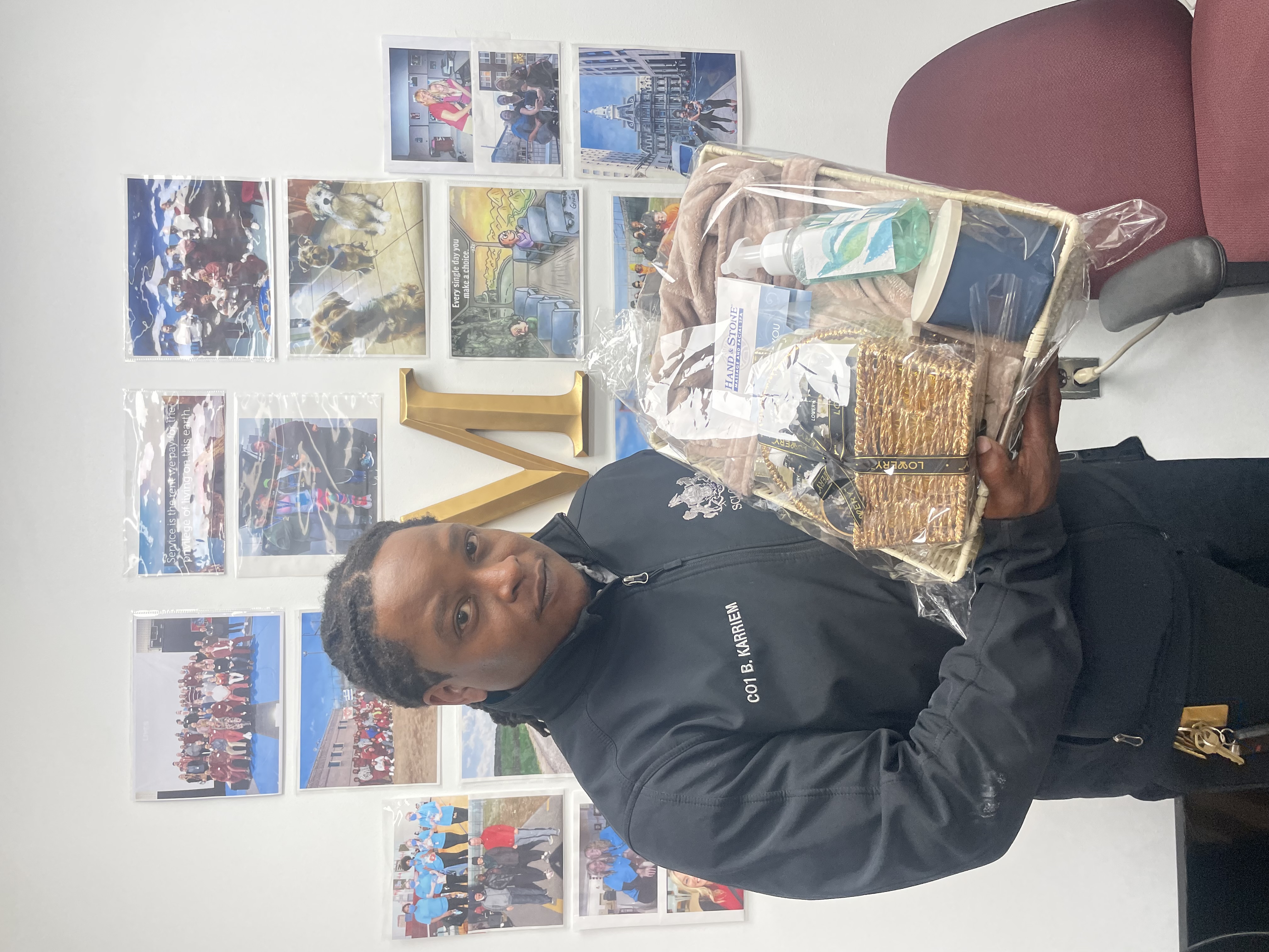 A DOC employee holding a gift basket