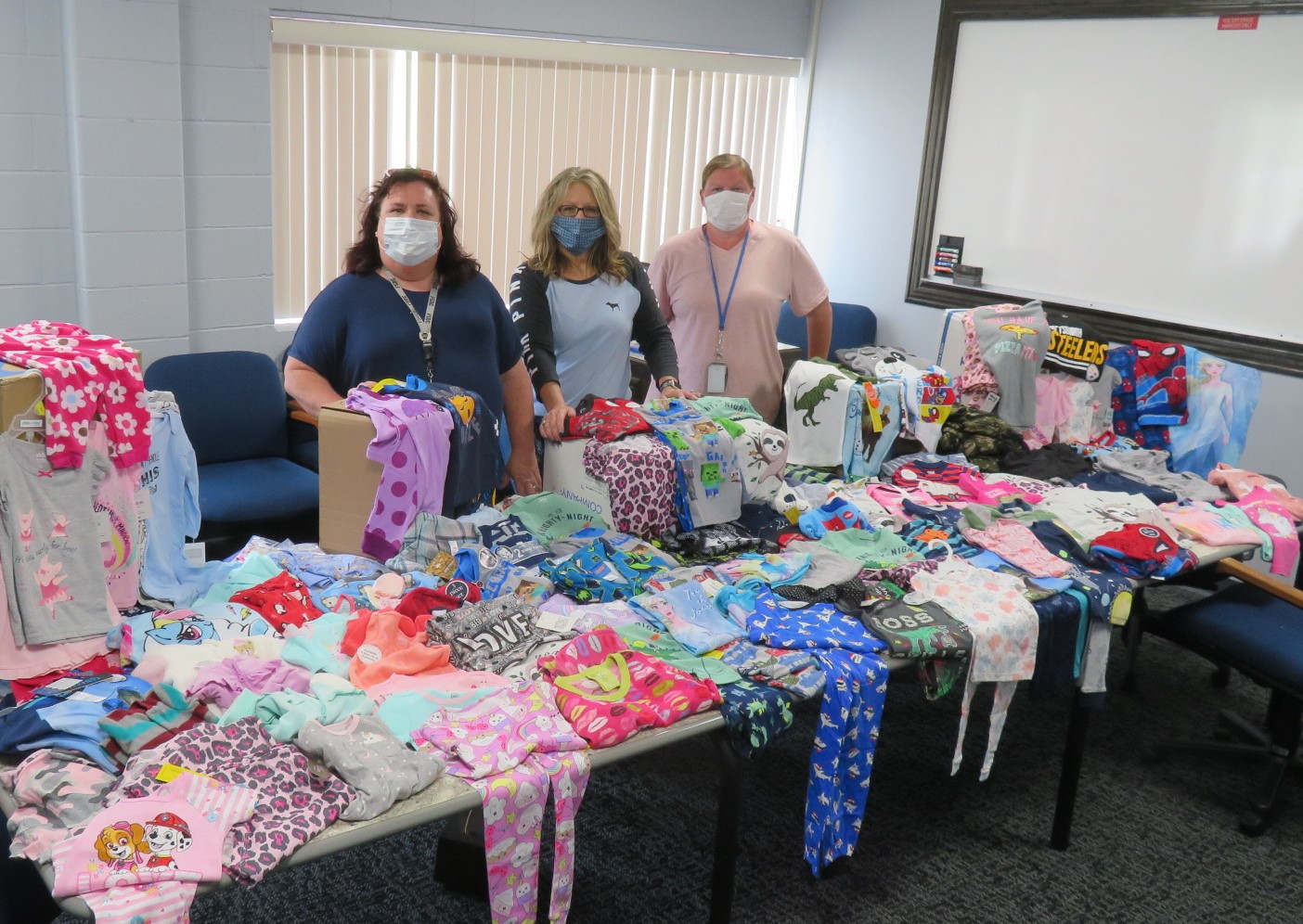 SCI Greene staff stand with their donation of pajamas