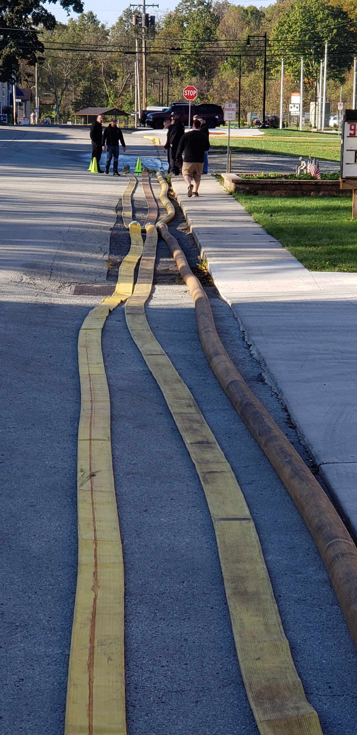 Long firehoses stretched along the street
