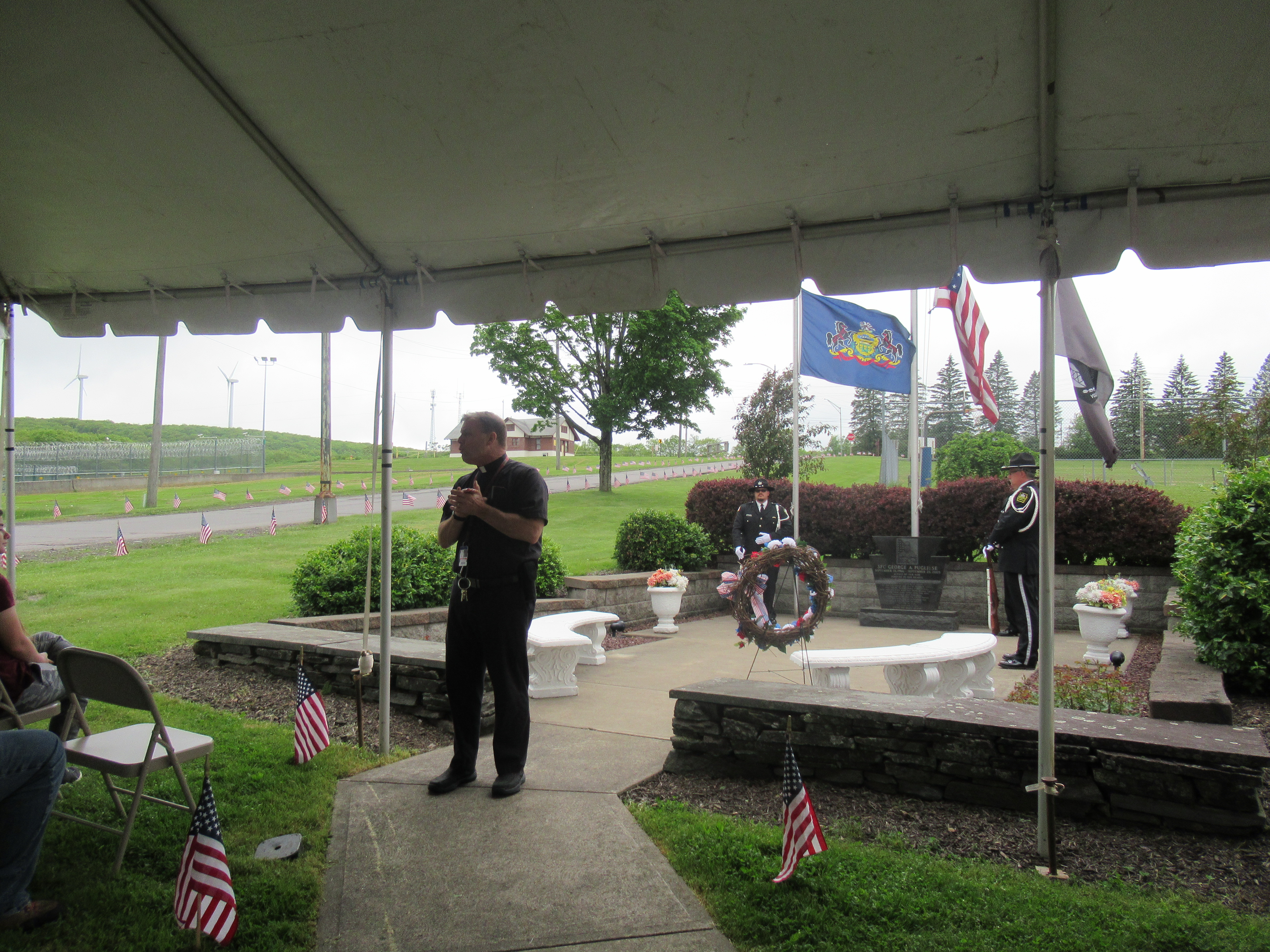 A person speaks to a crowd at a Memorial Day ceremony