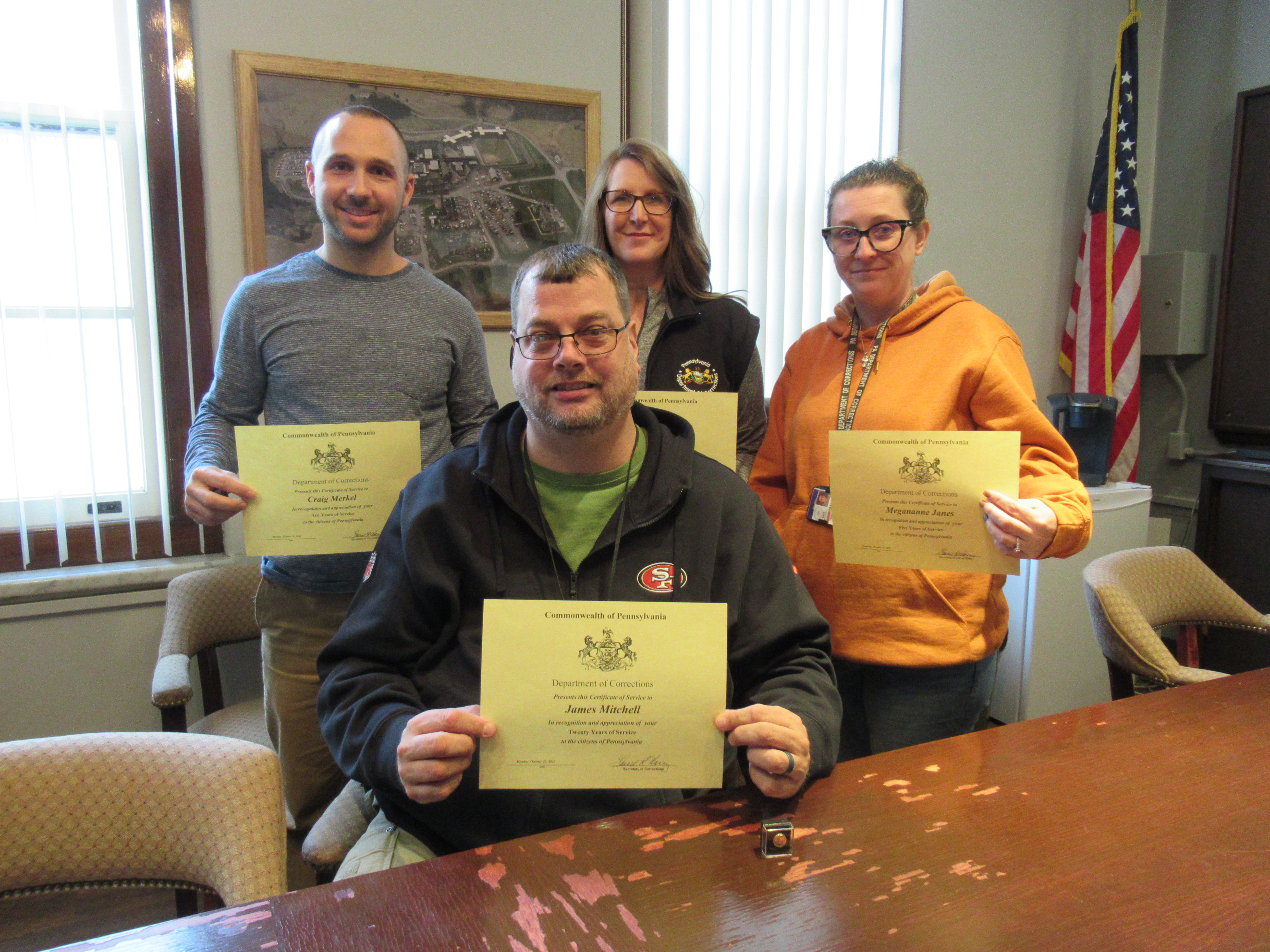 Four SCI Waymart employees hold their certificates in honor of their years of service.