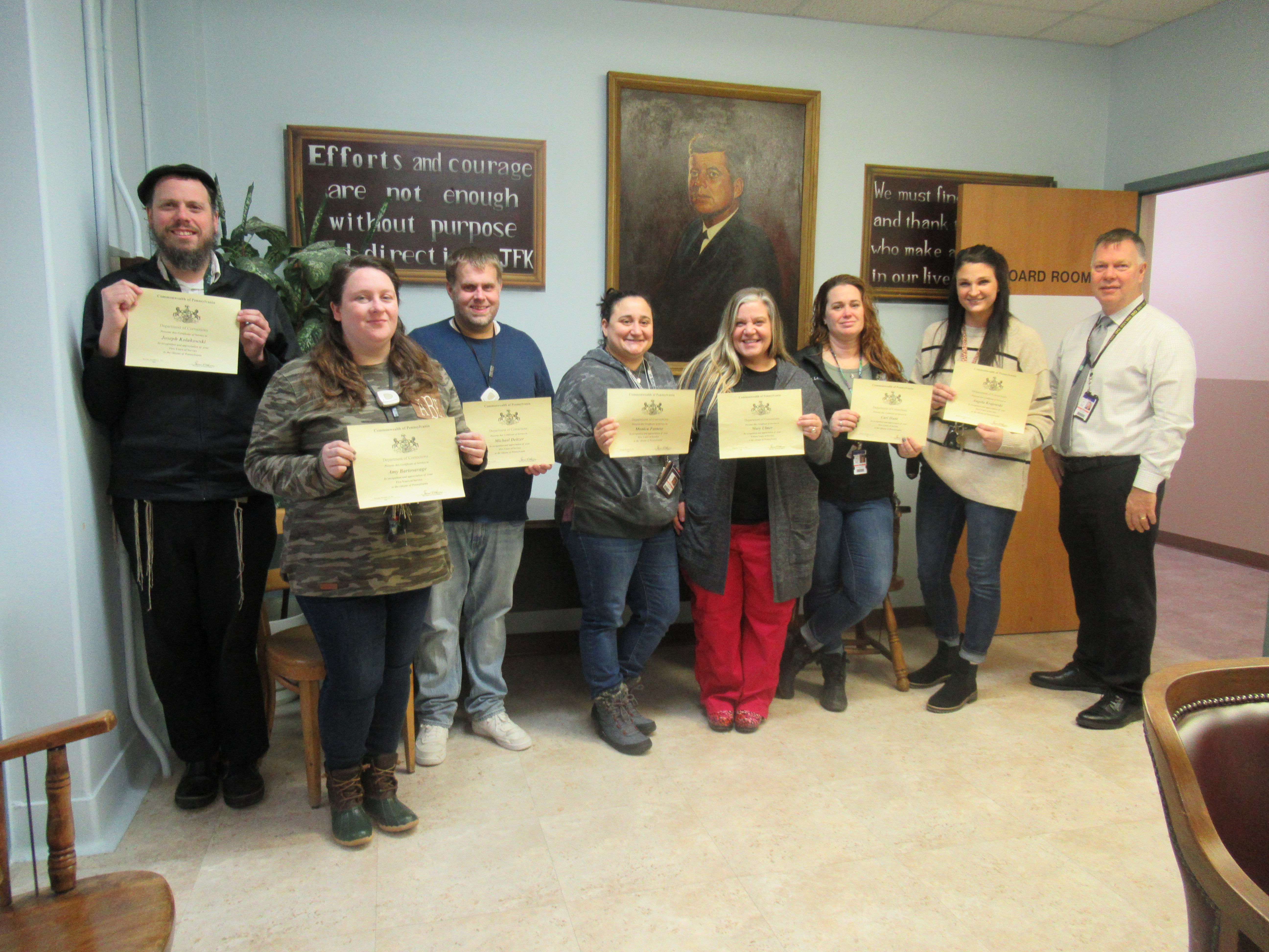 A group of people holding certificates.
