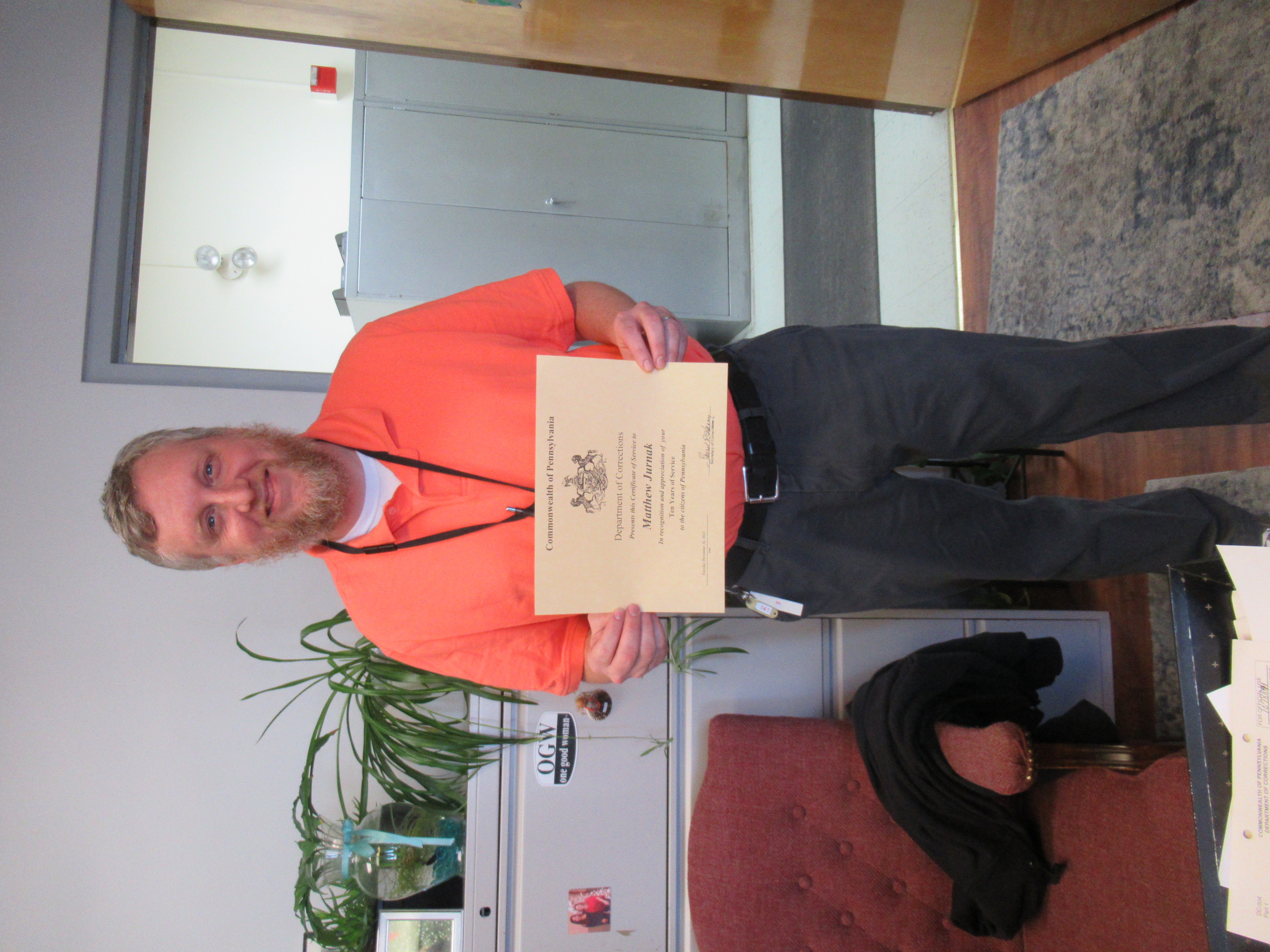 Librarian Matthew Jurnak holding a certificate